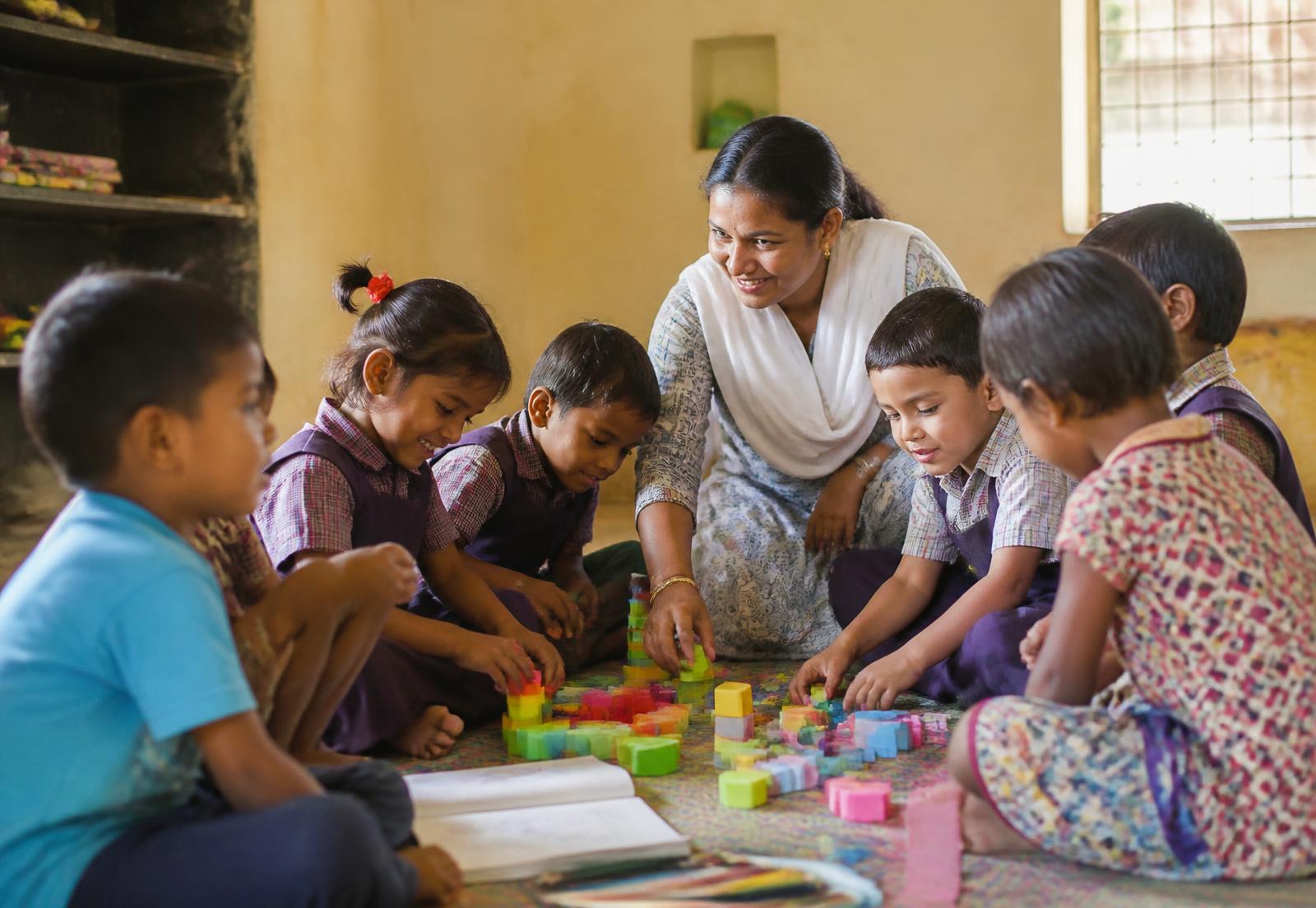 Pre-primary children learning through activity with their teacher
