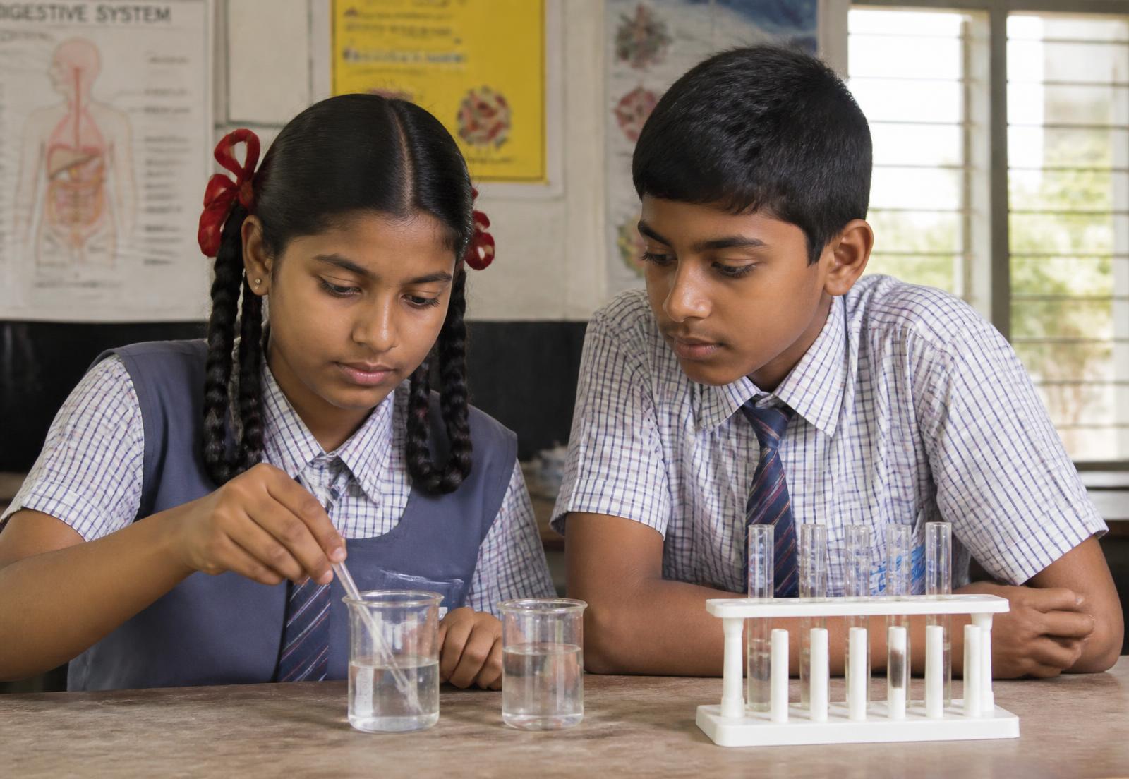 Students performing a science experiment in the school laboratory
